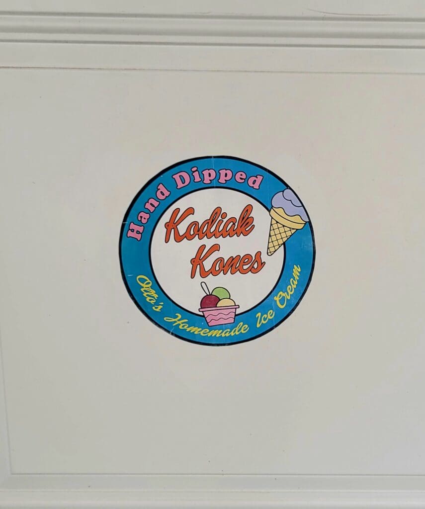 A circular blue and cream colored rodeo Kansas badge or emblem with decorative text displayed against a white background.