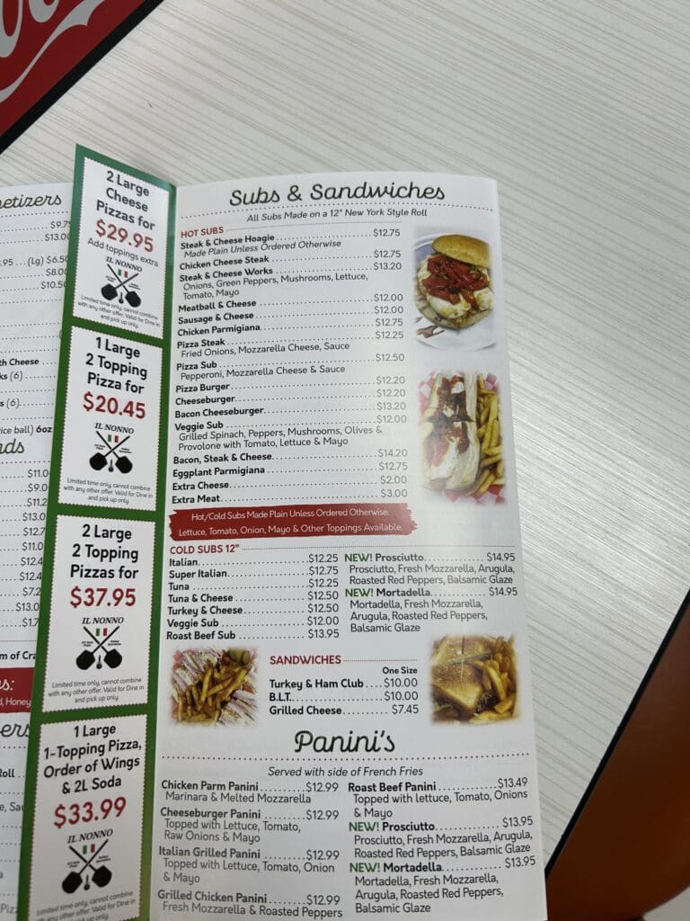 A restaurant menu displaying various food items with photographs, descriptions, and pricing information in a flat lay overhead composition.