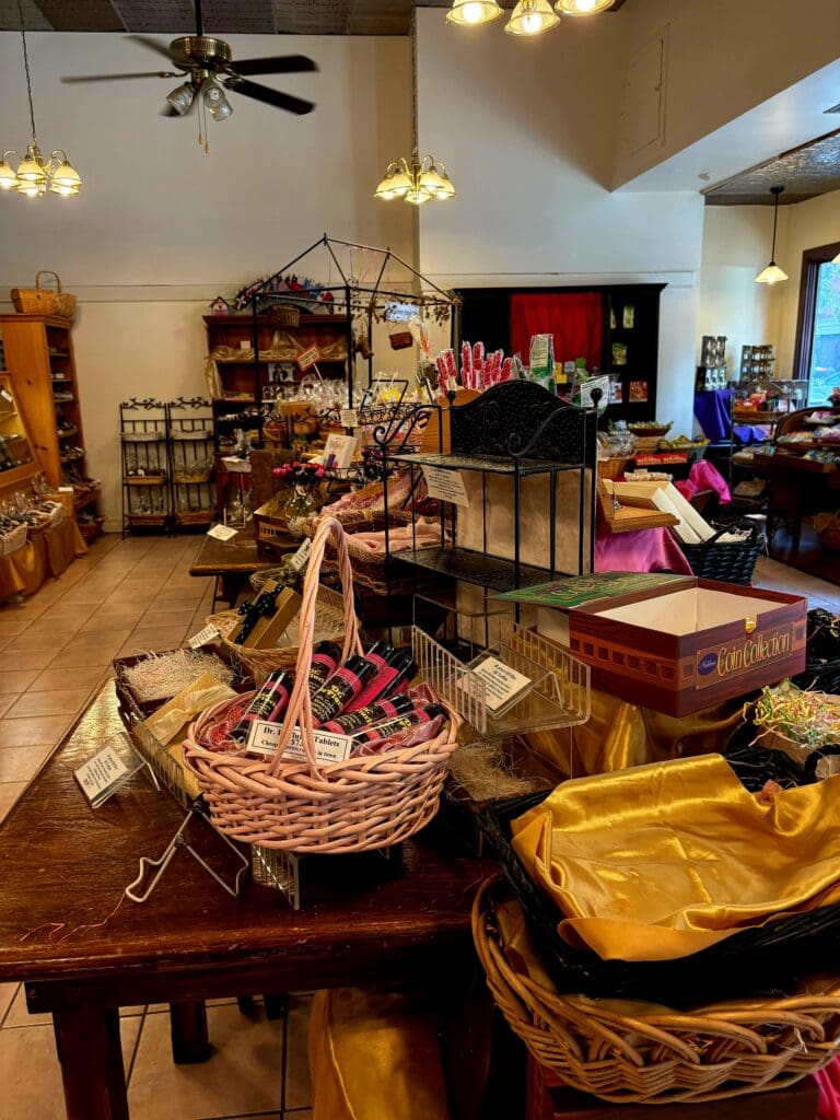 A well-organized craft workshop or studio space filled with handmade baskets, decorative items, and various crafting materials arranged on tables and shelves.