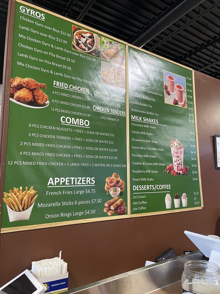 A restaurant menu board displayed on a green and brown wall showing various food items including combos, appetizers, and beverages with images and pricing.