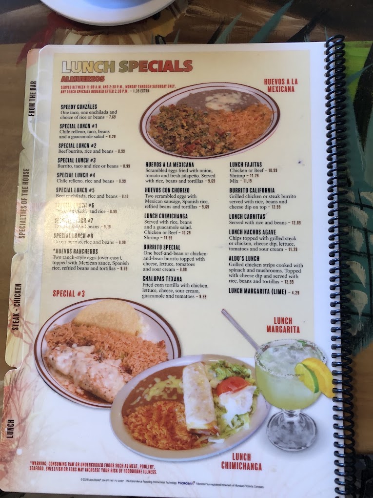A spiral-bound restaurant menu page featuring Mexican food specialties with full-color photographs of dishes and descriptive text.