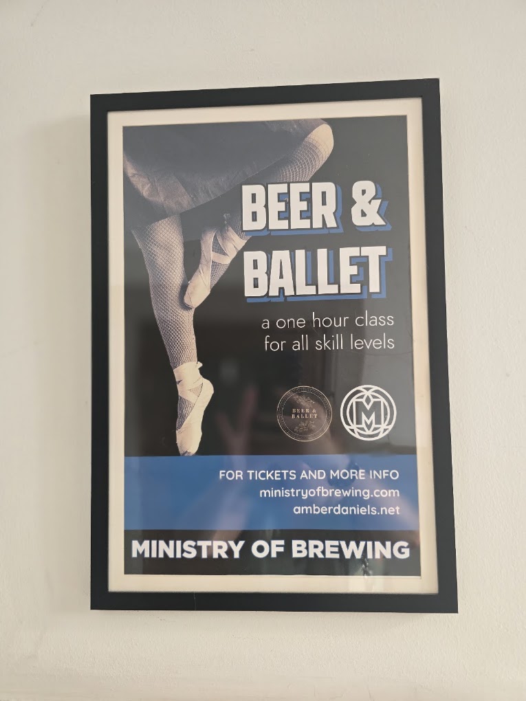 A framed promotional poster for a 'Beer & Ballet' event by Ministry of Brewing featuring a ballet dancer and text advertising the event for all drink types.